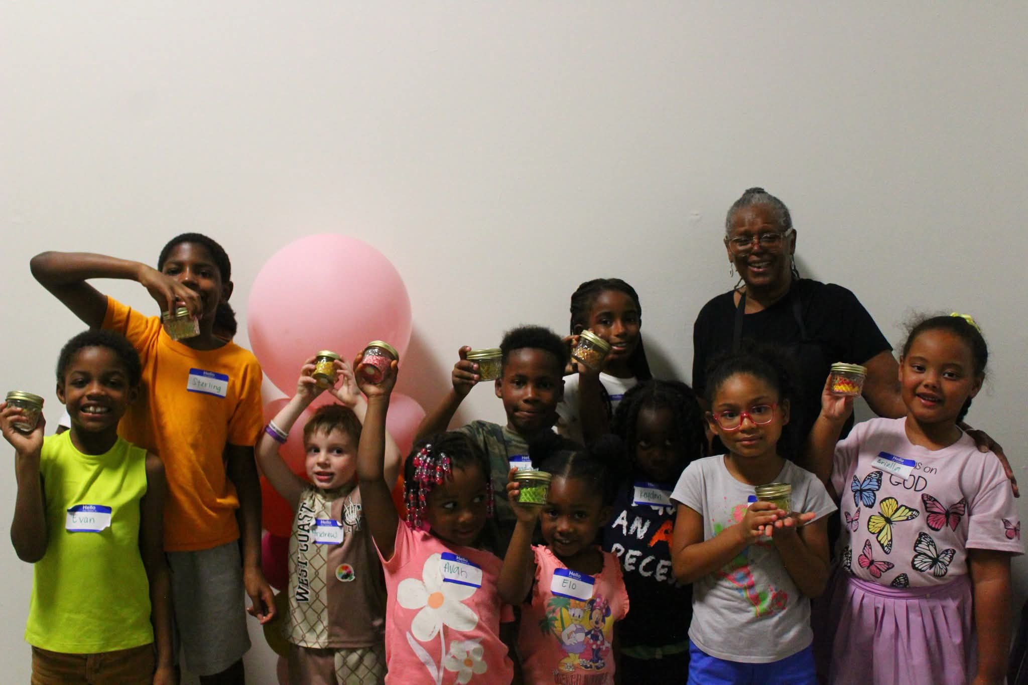 Helen and the Little Makers showing their completed candle jars