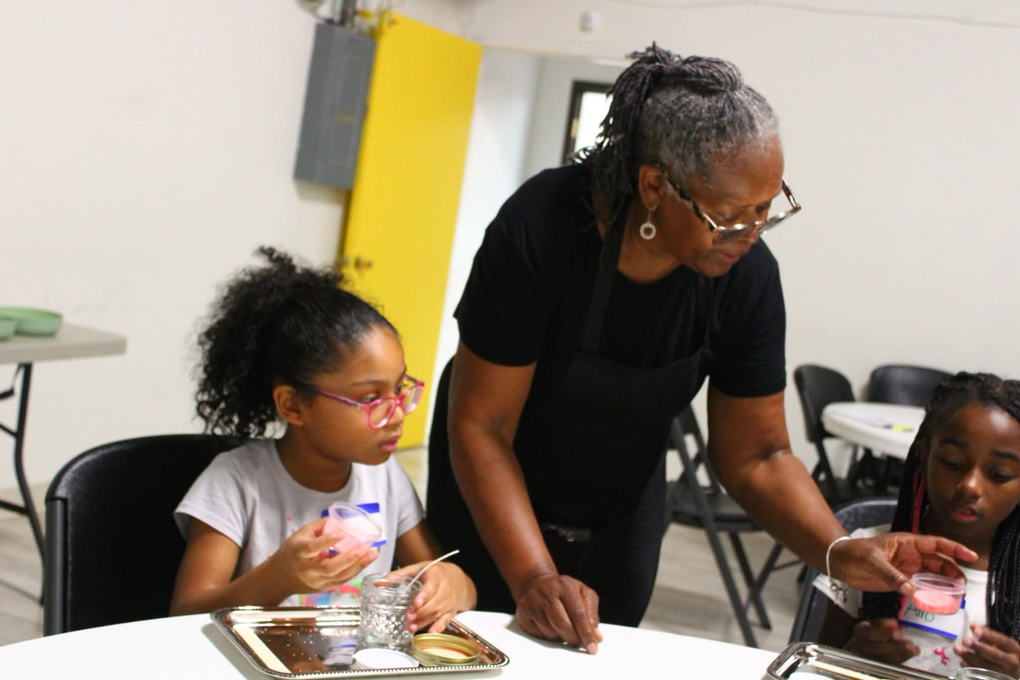 Helen leading a hands-on candle workshop with children